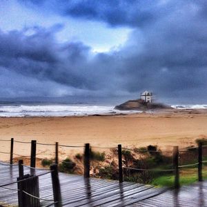 Scenic view of sea against cloudy sky