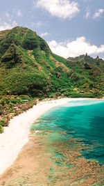 Scenic view of sea and mountains against sky