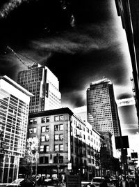 Low angle view of buildings against cloudy sky