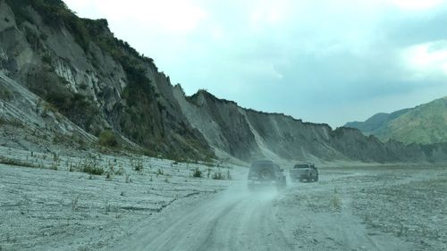 Road amidst mountains against sky