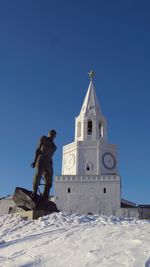 Low angle view of cross against clear blue sky