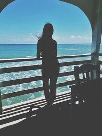 Rear view of woman looking at sea against sky