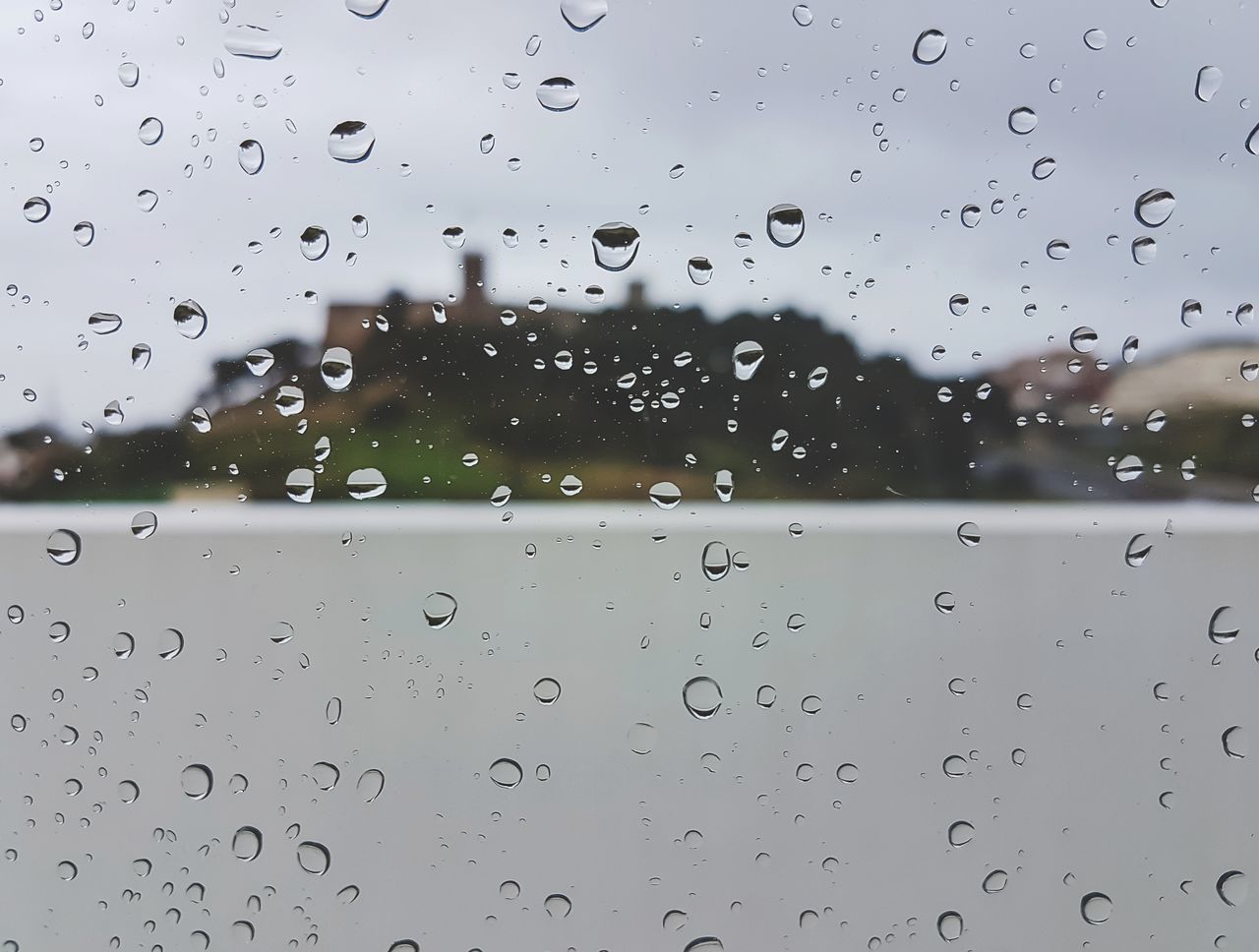 FULL FRAME SHOT OF WET WINDOW IN RAINY SEASON