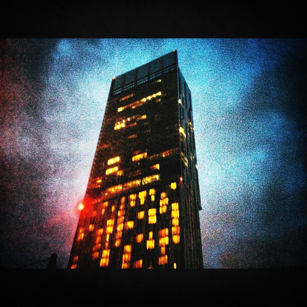 architecture, building exterior, built structure, low angle view, night, illuminated, sky, tower, city, tall - high, auto post production filter, building, no people, outdoors, dusk, transfer print, sunset, modern, skyscraper, cloud - sky