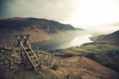 High angle view of lake and mountains against sky