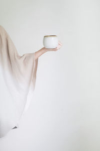 Woman in a robe holding a cup of coffee