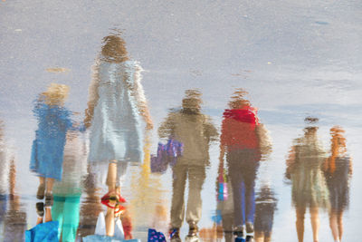 High angle view of people walking in water