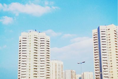 Low angle view of buildings against blue sky