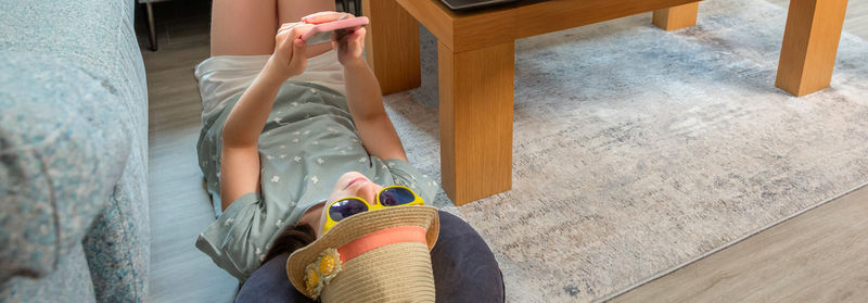 Low section of man standing on hardwood floor