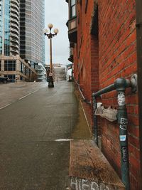 Diminishing perspective of street amidst buildings in city