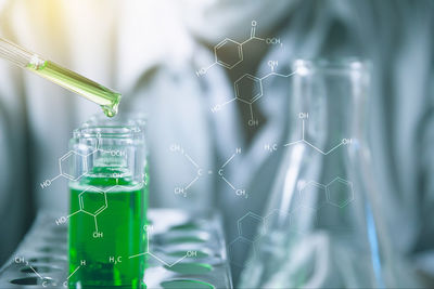 Digital composite image of man examining chemical in laboratory