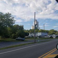 View of country road against cloudy sky