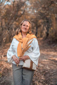 Portrait of a smiling young woman in forest