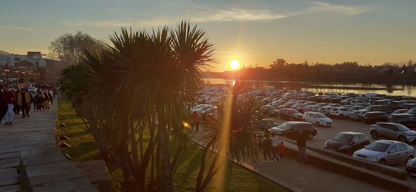 Panoramic view of people on street at sunset