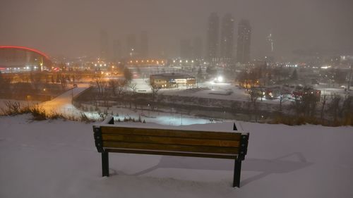 Illuminated city against sky during winter