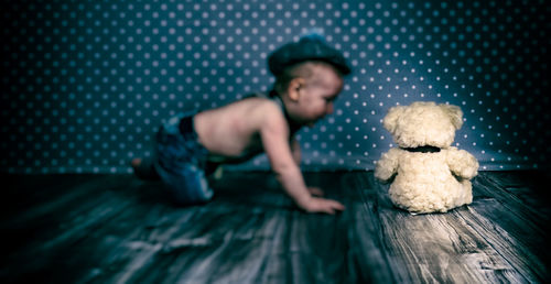 Boy sitting on toy while looking away