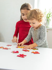 Portrait of boy playing with toy blocks at home