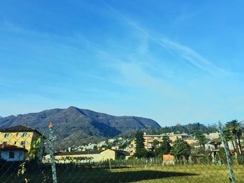 Houses and buildings against blue sky