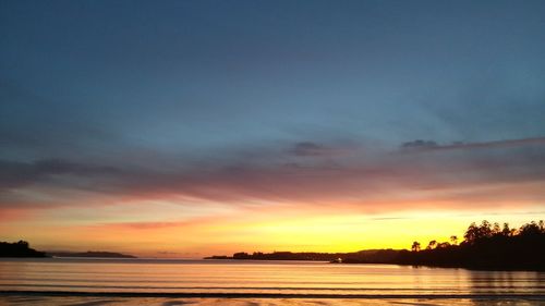 Scenic view of lake against romantic sky at sunset