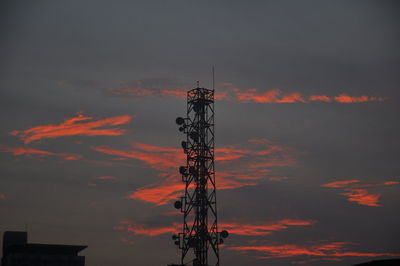 Low angle view of communications tower against sky during sunset