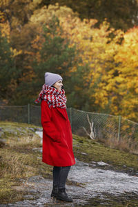 Rear view of woman standing on field