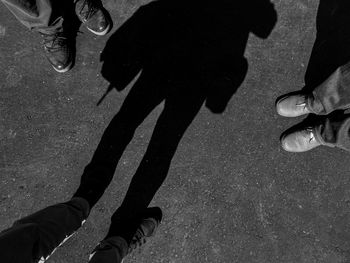 Low section of man walking on street