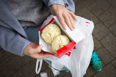 Midsection of woman holding food outdoors