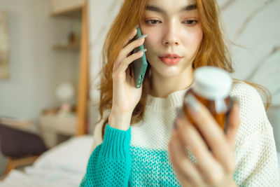 Portrait of beautiful woman drinking at home