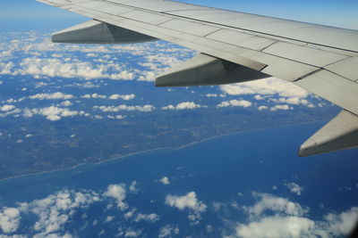 Aerial view of aircraft wing over landscape