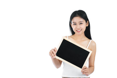 Portrait of a smiling young woman over white background