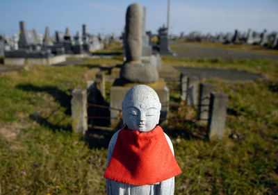 Close-up of ksitigarbha bodhisattva statue at cemetery