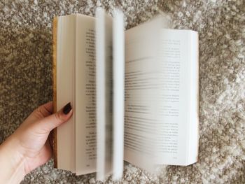 Close-up of hand holding book