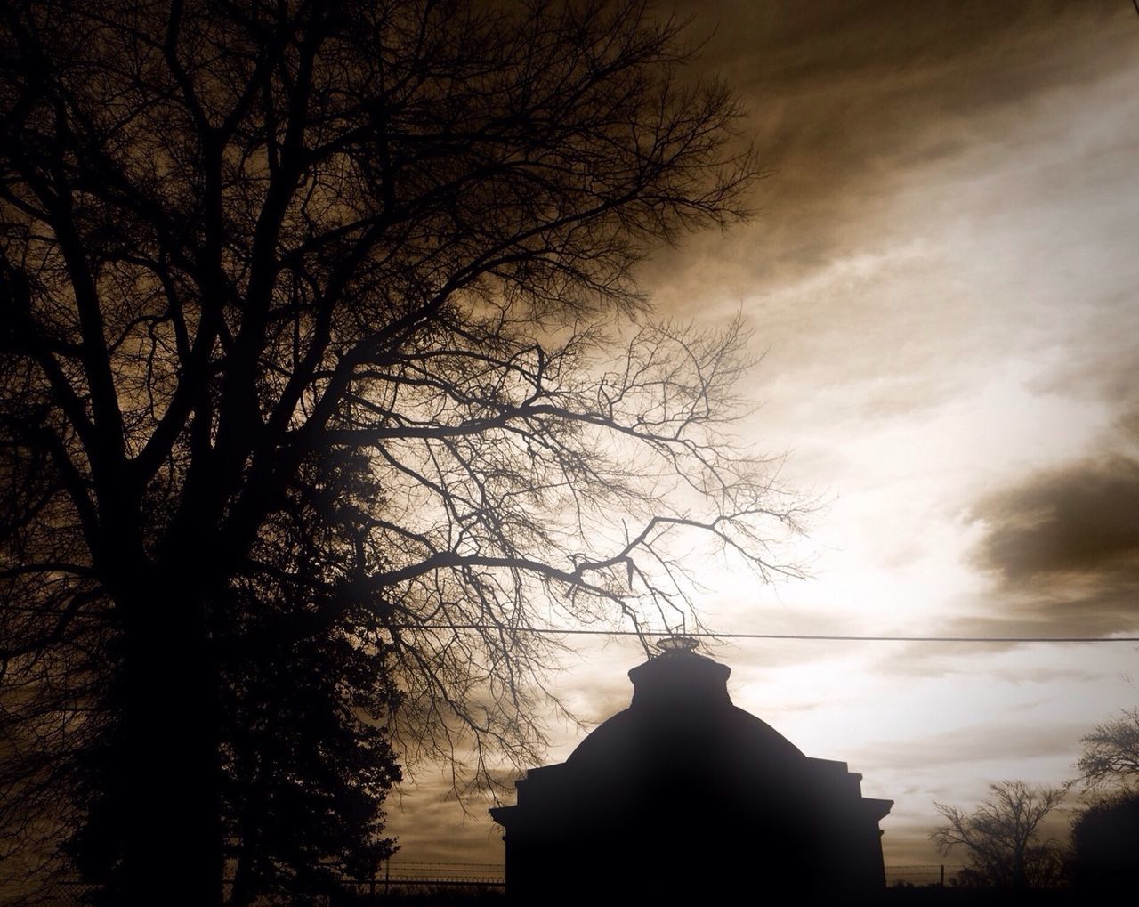 tree, silhouette, bare tree, sky, branch, sunset, cloud - sky, built structure, low angle view, architecture, building exterior, dusk, nature, tranquility, cloudy, cloud, beauty in nature, outdoors, spirituality, no people