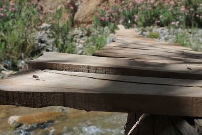 Close-up of empty bench in park