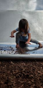 High angle view of girl playing on shore