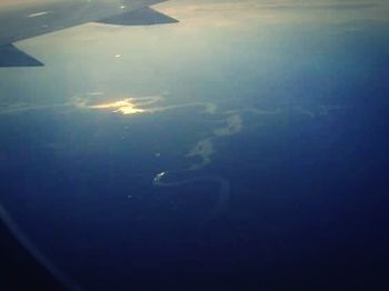 Cropped image of airplane flying over landscape