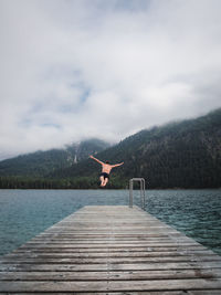 Rear view of man diving in lake