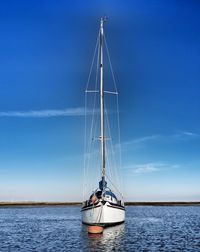 Sailboat sailing on sea against sky