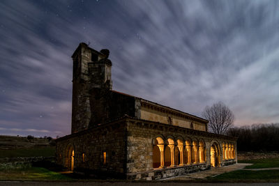 Low angle view of old building against sky at night