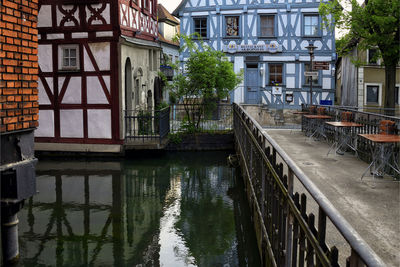 Canal by buildings in city