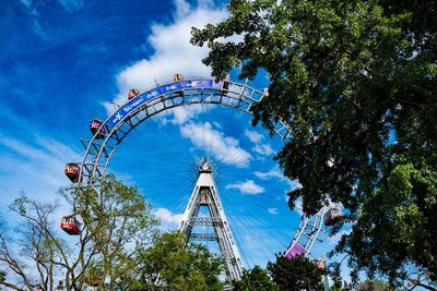 Low angle view of ferris wheel against sky