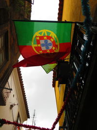 Low angle view of flags hanging against sky