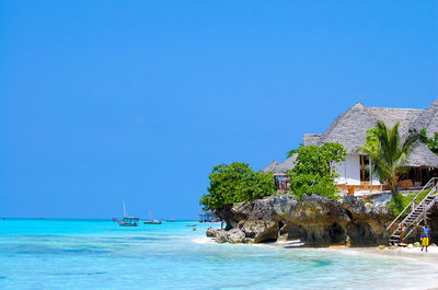 Scenic view of sea against clear blue sky