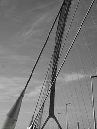 Low angle view of suspension bridge against sky