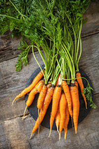 Healthy ripe juicy carrots on a wooden kitchen table. the concept of organic nutrition. 