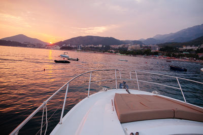 Boat sailing in sea against sky during sunset