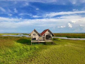 House on field against sky