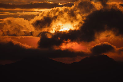 Scenic view of dramatic sky at sunset