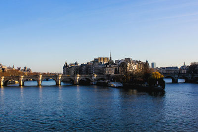 Bridge over river with city in background