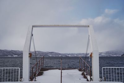 Bridge over sea against sky